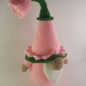 A crochet spring flower gnome with a white background