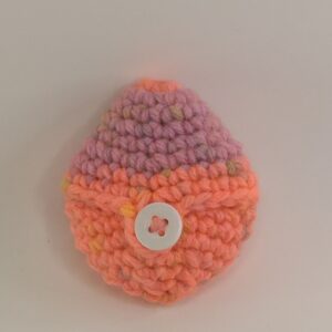 A crochet reusable easter egg with a white background