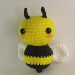 A crochet bee with a white background